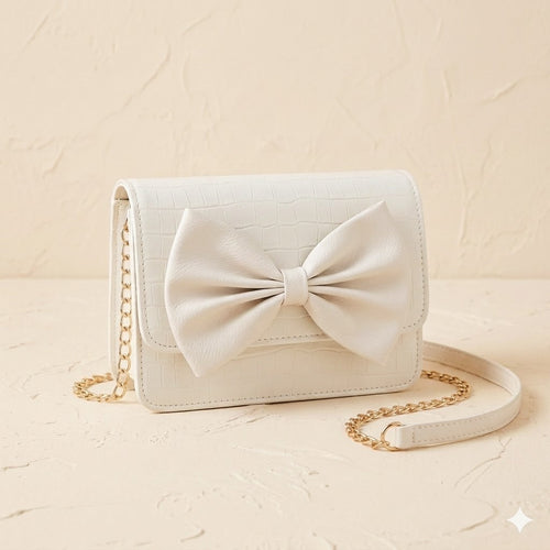 White handbag with a large bow on a beige background