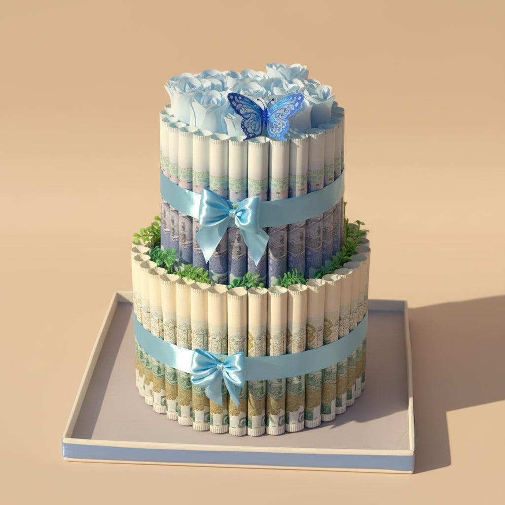 Two-tier diaper cake with blue decorations on a table with a teal chair and white wall in the background.