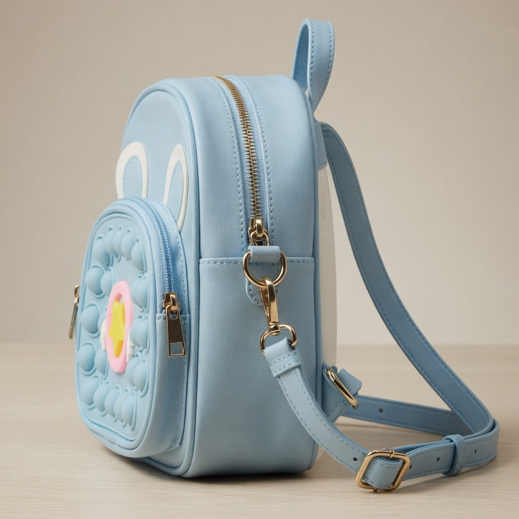 Light blue backpack with animal face design on a beige background
