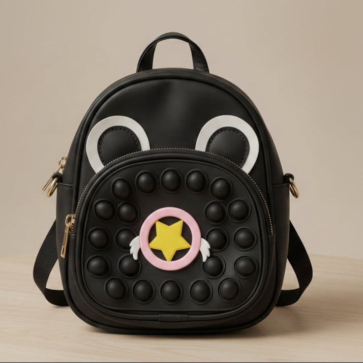 Black backpack with cartoon face design on a beige background