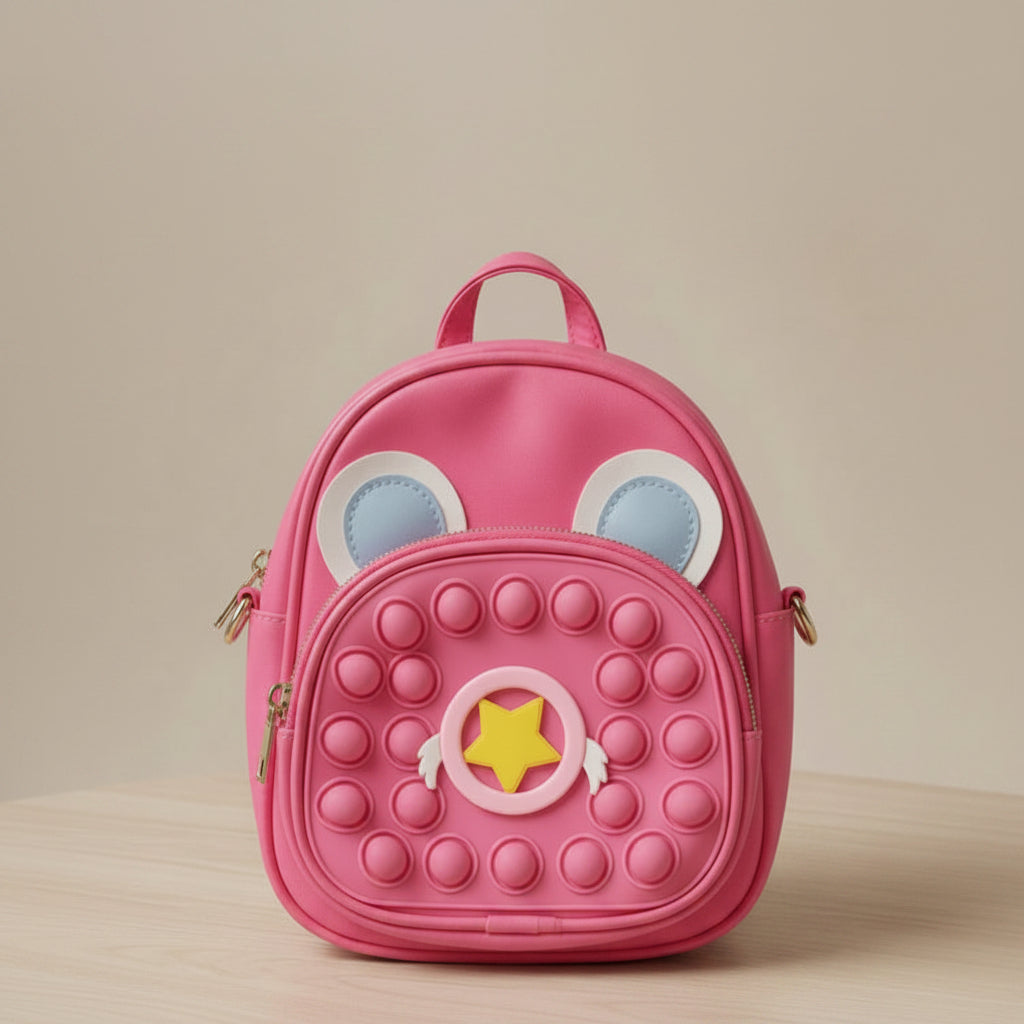 Pink backpack with eye-like designs and a star on a beige background