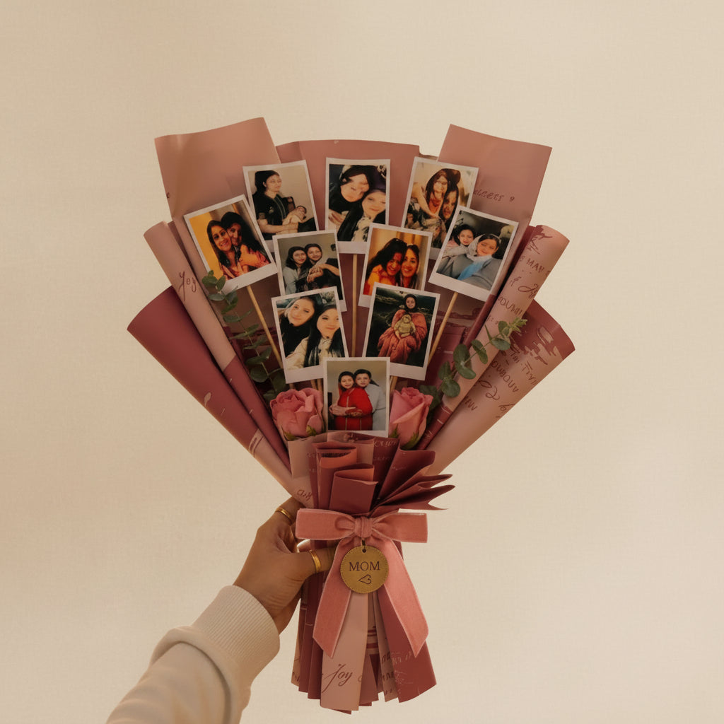 Bouquet made of photos and pink paper on a wooden table