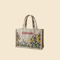 Beige tote bag with floral embroidery and 'Sookhri' branding on a beige background